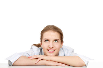 A young college girl at the desk, looking up