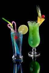 green cocktail with pineapple and blue cocktail