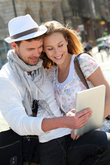 Couple in town using electronic tablet