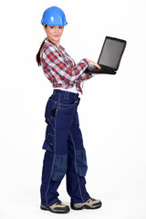 Female construction worker with a laptop