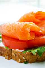 Smoked salmon sandwich with tomato and rye bread