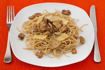 spaghetti with mushrooms and cheese on the plate