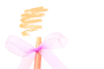 Fototapeta premium foundation/concealer pencil with stroke on white