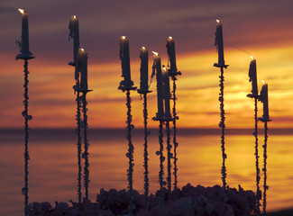 Candles in the beach at sunset