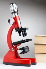 books and microscope, scientific or educational concept