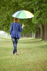 Young fashion girl with umbrella at spring outdoor.