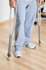 Woman Standing With Crutches