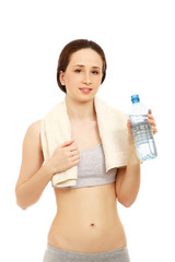 A woman in a sport costume drinking water