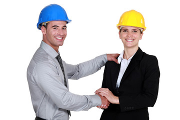 foreman shaking hands with female architect