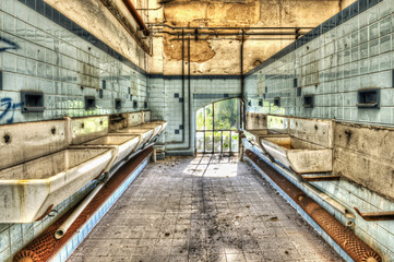 Derelict washbasins in the communal shower room of an abandoned - 41841014