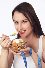 Young woman with a bowl of breakfast cereals