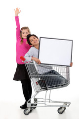 Children with a shopping trolley and blank board