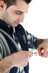 closeup of young electrician at work