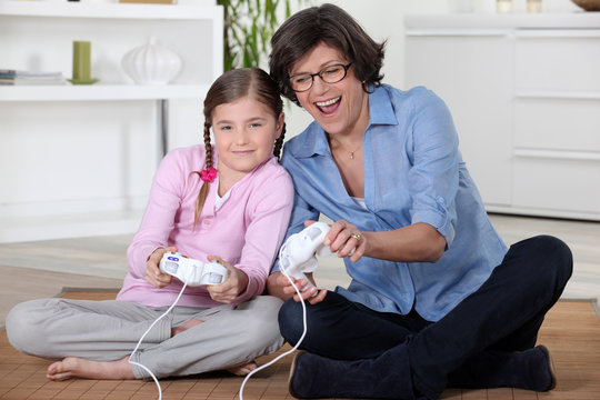 Girl and her grandmother playing computer games