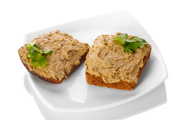 Fresh pate on bread on white plate isolated on white