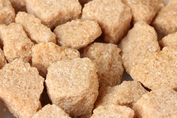 brown cane sugar cubes background close-up
