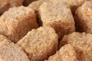 brown cane sugar cubes background close-up