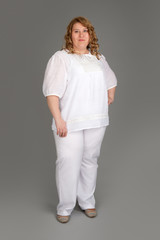 smiling fat woman on gray background