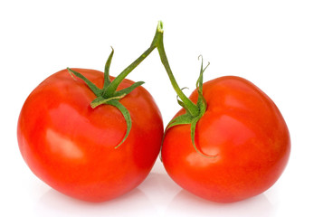 Two ripe tomatoes on a white background