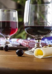 wine cheese and olives on wood table