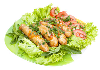 sausage with lettuce leaves, isolated on white background
