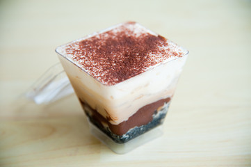 Piece of Banoffee cake on wood pattern background