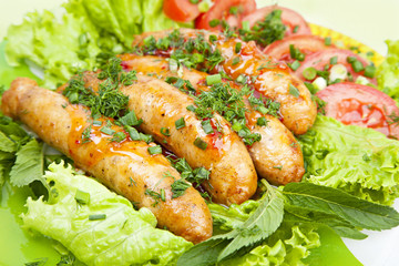 sausage with lettuce leaves, close-up
