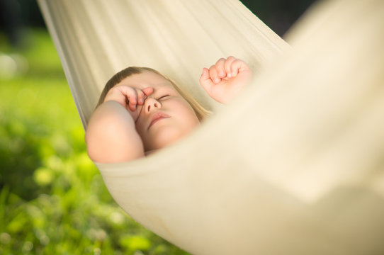 Adorable Baby Sleep Quiet In Hammock On Sun