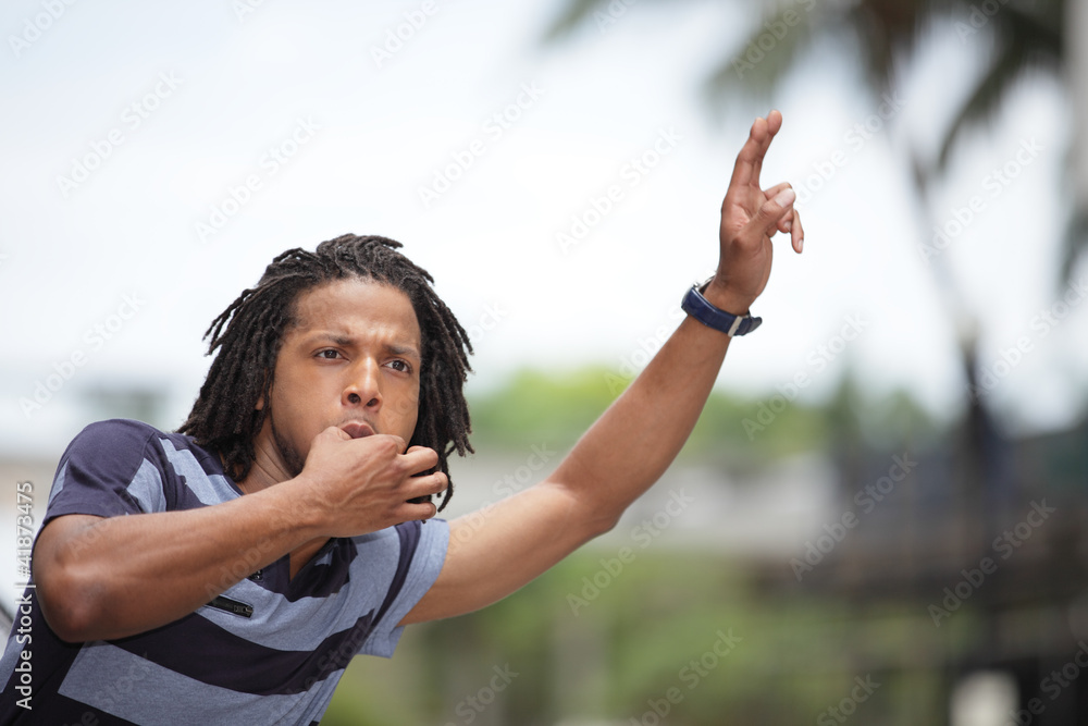 Wall mural man whistling for a cab