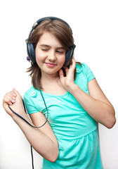 attractive teen girl with headphones on white background