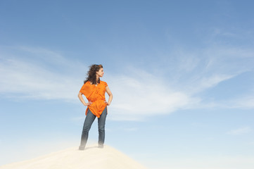 Beautiful and confident woman on top of hill