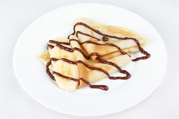 Thin pancakes with banana and chocolate