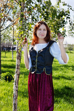 Medieval woman near the birch