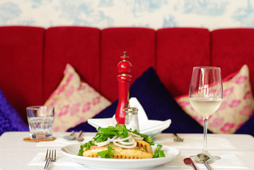 Fine restaurant dinner table place setting: napkin, wineglass, p