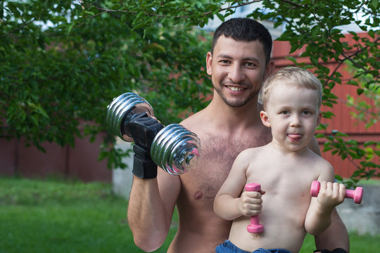 Father and son train with dumbbells