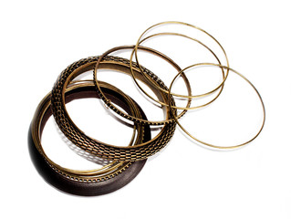 metal and wooden bracelets in ethnic style on a white background