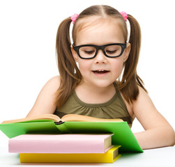 Cute little girl reading book