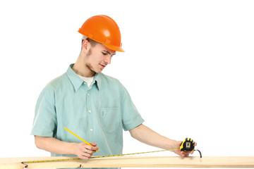 A young construction worker measuring
