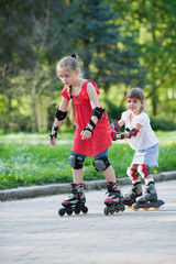 Sisters skating in park
