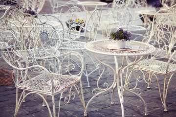 Lavender on the white metal table in Provence style street cafe