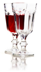 Glass of red wine and empty glass with reflection.
