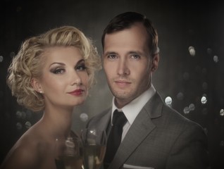 Retro couple with glasses of champagne portrait