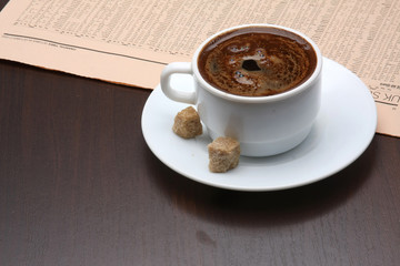 A cup of coffee and a newspaper