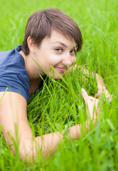 Young Woman relaxing on the green grass