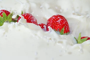 Keuken foto achterwand Milkshake Fresh strawberries falling into the milk with a splash closeup
