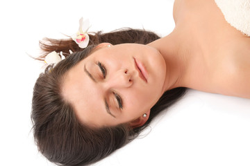 A beautiful young woman with flowers in her hair, closeup