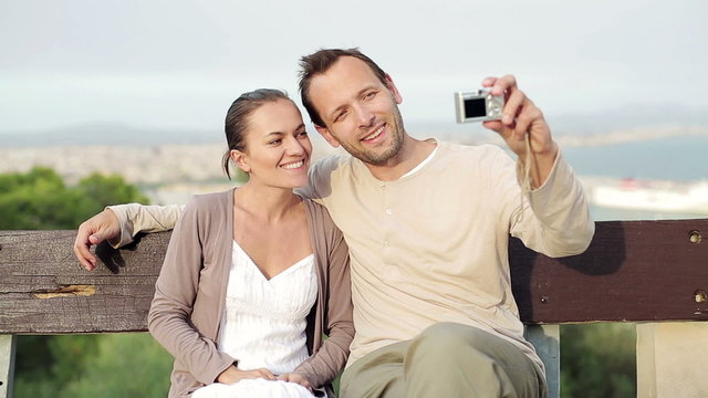 Happy couple taking photo, outdoors