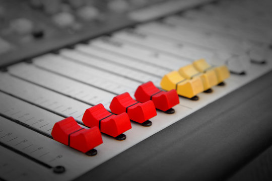Close up of red and yellow audio sound mixer