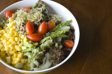 mixed salad on wood background