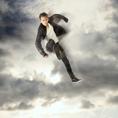 Cool young man jumping and kicking
